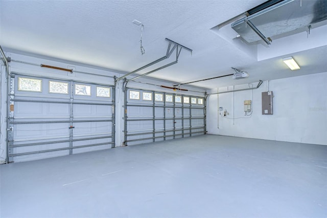 garage featuring a garage door opener and electric panel