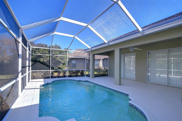 view of pool featuring a lanai, ceiling fan, and a patio area