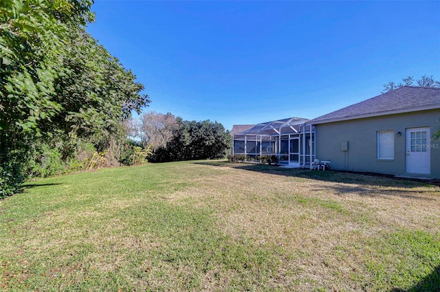 view of yard with glass enclosure