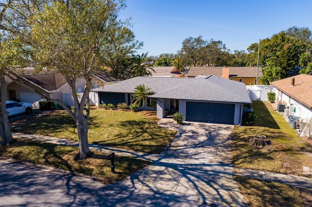 ranch-style home featuring a garage and a front lawn