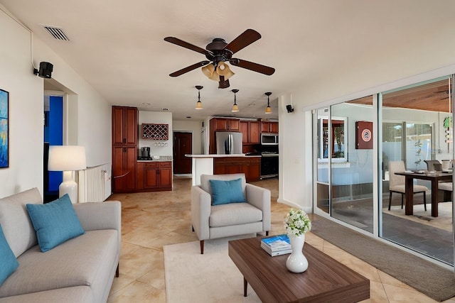 living room with ceiling fan, radiator heating unit, and light tile patterned floors