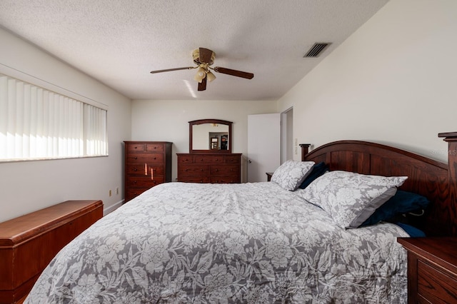 bedroom with ceiling fan and a textured ceiling