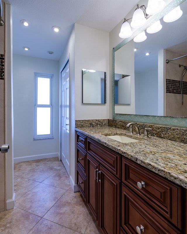 bathroom featuring walk in shower, vanity, and tile patterned flooring