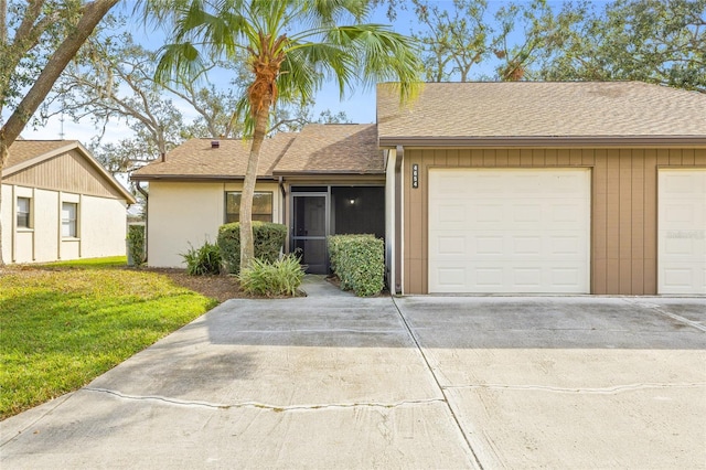 ranch-style house with a garage and a front lawn