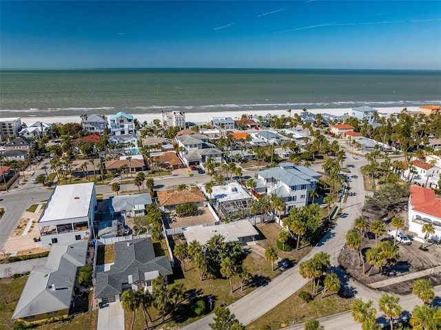 birds eye view of property featuring a beach view and a water view