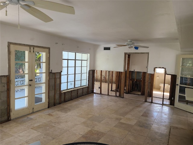 unfurnished room with ceiling fan and french doors