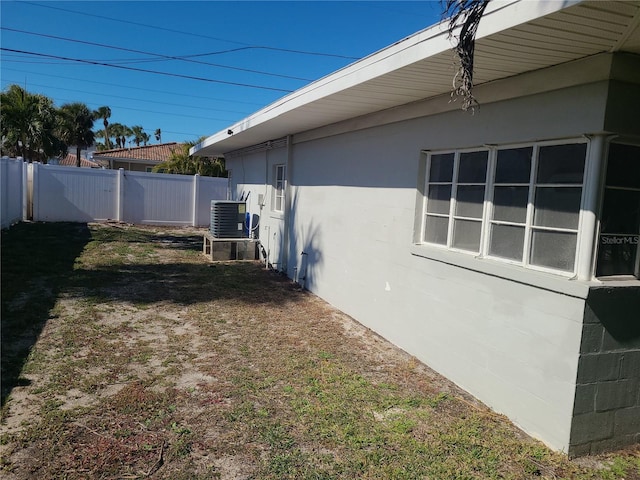 view of side of property with central AC unit