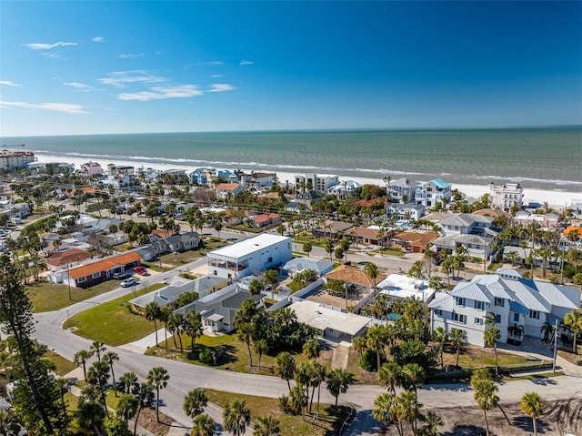 drone / aerial view featuring a water view and a view of the beach