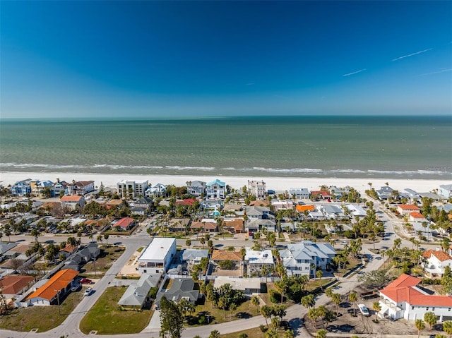 birds eye view of property with a beach view and a water view