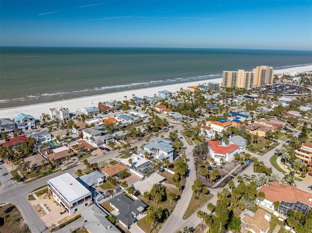 drone / aerial view with a water view and a beach view