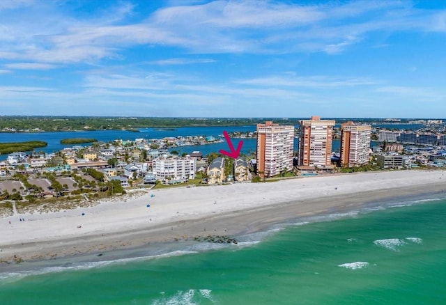 birds eye view of property with a beach view and a water view