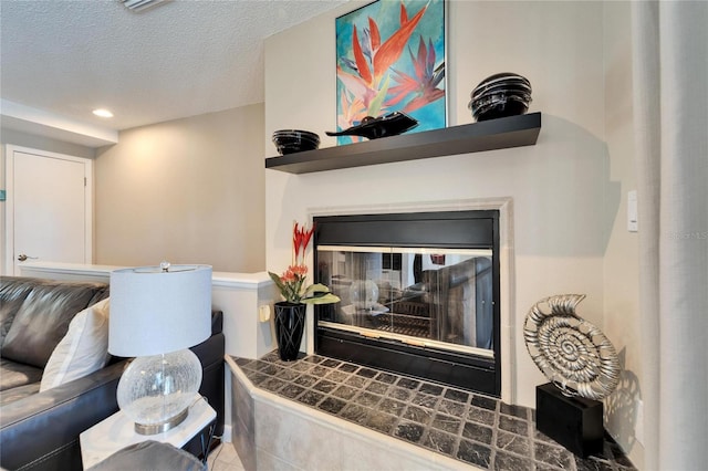 living room featuring a multi sided fireplace and a textured ceiling