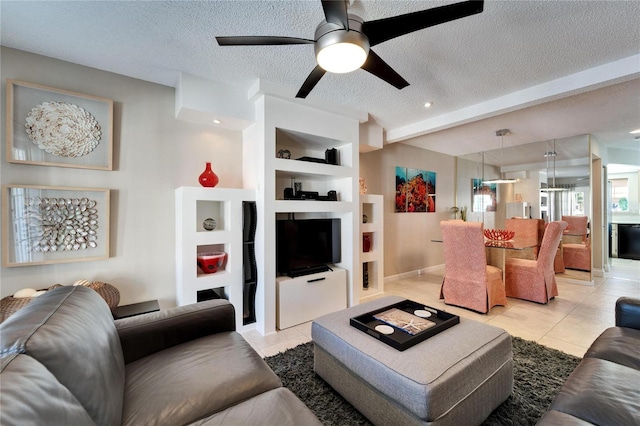 tiled living room featuring built in shelves, ceiling fan, a textured ceiling, and beamed ceiling