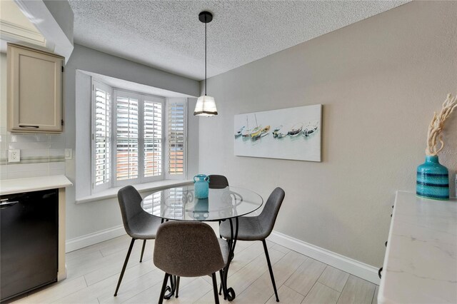 dining area featuring a textured ceiling