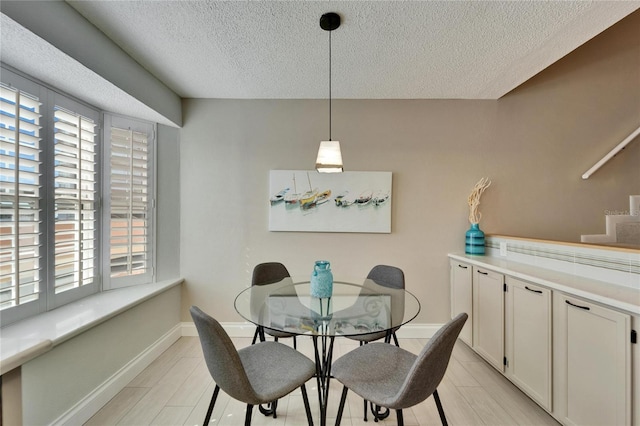 dining room with a textured ceiling