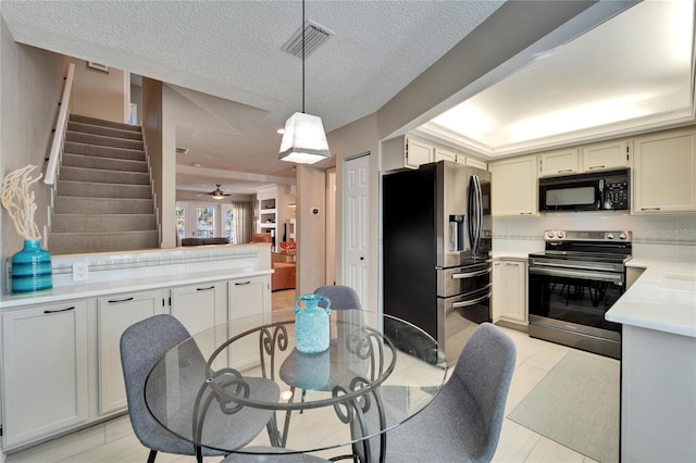 dining space with ceiling fan and a textured ceiling