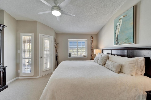 carpeted bedroom with ceiling fan, a textured ceiling, and access to outside