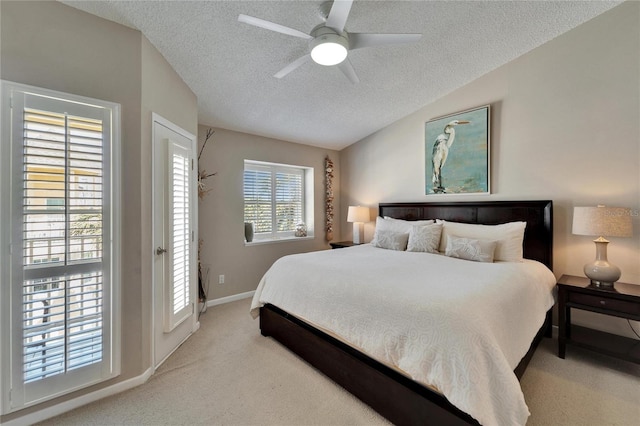 bedroom with light carpet, ceiling fan, vaulted ceiling, and a textured ceiling