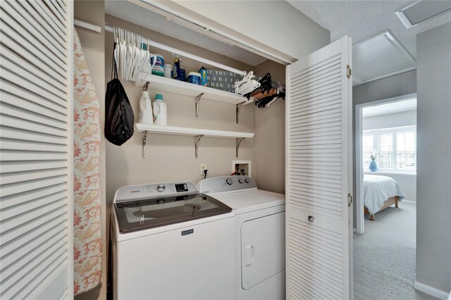 laundry room with washer and clothes dryer and light colored carpet