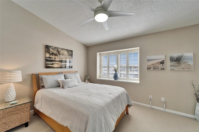 carpeted bedroom featuring ceiling fan, lofted ceiling, and a textured ceiling