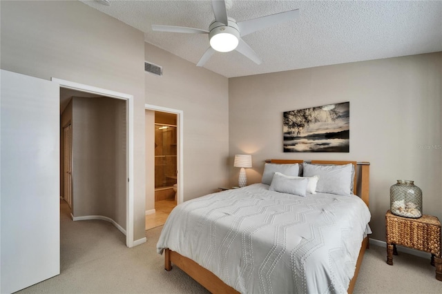 carpeted bedroom with ceiling fan, connected bathroom, and a textured ceiling