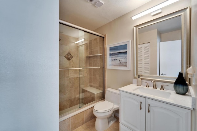 bathroom with vanity, an enclosed shower, tile patterned flooring, and toilet