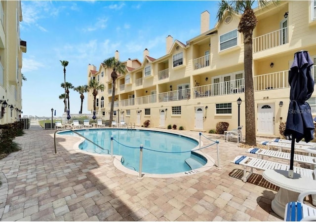 view of swimming pool featuring a patio area