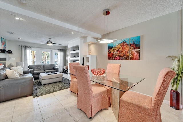 17960 Gulf Blvd Unit 103, Redington Shores, FL 33708 - dining room featuring light tile patterned flooring, beam ceiling, a textured ceiling, a ceiling fan, and visible vents