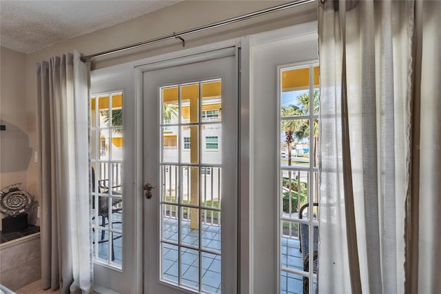 17960 Gulf Blvd Unit 103, Redington Shores, FL 33708 - doorway featuring plenty of natural light and a textured ceiling