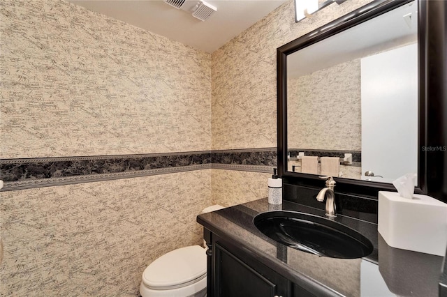 17960 Gulf Blvd Unit 103, Redington Shores, FL 33708 - bathroom featuring toilet, wallpapered walls, visible vents, and vanity
