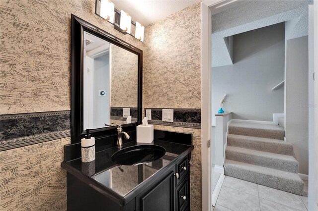 17960 Gulf Blvd Unit 103, Redington Shores, FL 33708 - bathroom featuring vanity, baseboards, tile patterned flooring, and wallpapered walls