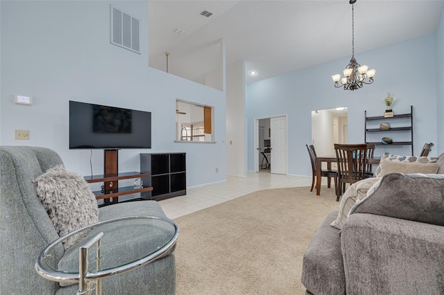 living room with light carpet, a notable chandelier, and a towering ceiling