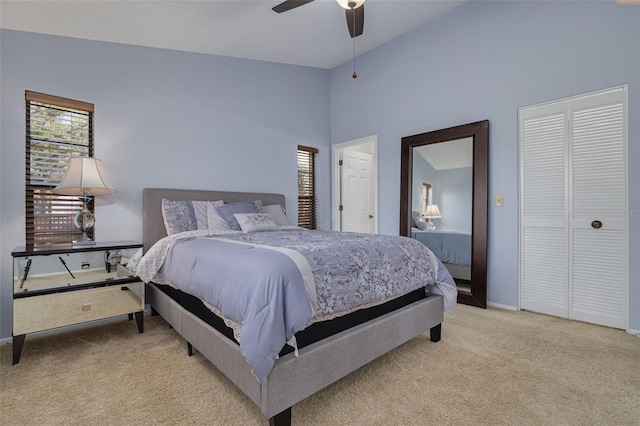 carpeted bedroom featuring ceiling fan and high vaulted ceiling