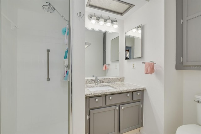 bathroom featuring walk in shower, vanity, and toilet