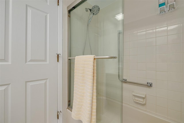 bathroom featuring shower / bath combination with glass door