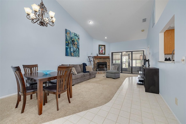 3985 Mermoor Dr, Palm Harbor, FL 34685 - dining room featuring light colored carpet, high vaulted ceiling, a fireplace with raised hearth, visible vents, and a notable chandelier