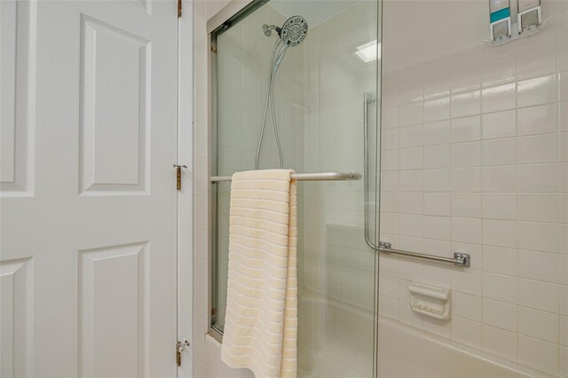 3985 Mermoor Dr, Palm Harbor, FL 34685 - bathroom featuring bath / shower combo with glass door