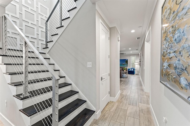 staircase with visible vents, baseboards, wood finish floors, and recessed lighting