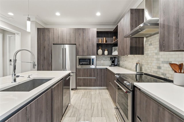 kitchen featuring modern cabinets, appliances with stainless steel finishes, light countertops, wall chimney range hood, and open shelves