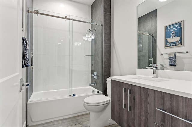 bathroom with shower / bath combination with glass door, vanity, toilet, and wood finished floors