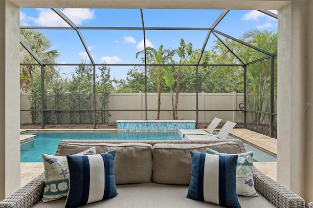 view of swimming pool with a lanai, a patio area, fence, and a fenced in pool