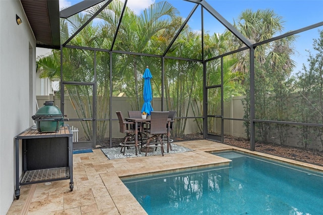 view of pool featuring a patio, a fenced backyard, a grill, and a lanai