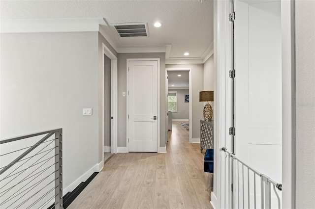 hallway with crown molding, recessed lighting, visible vents, light wood-style floors, and baseboards