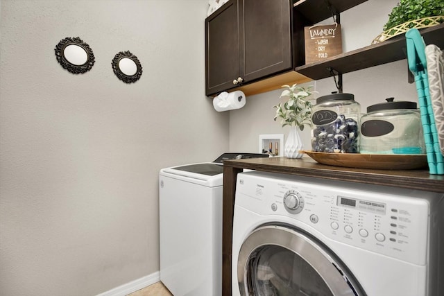 laundry area featuring cabinets and washing machine and clothes dryer