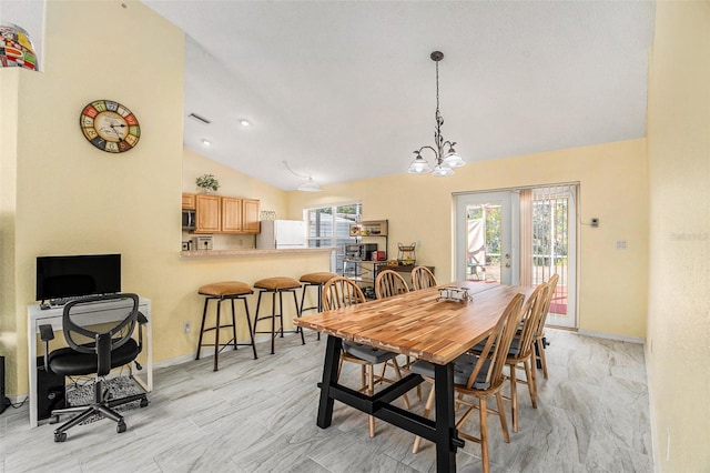 dining area with lofted ceiling and a wealth of natural light