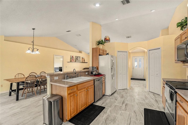 kitchen featuring decorative light fixtures, lofted ceiling, sink, a chandelier, and stainless steel appliances