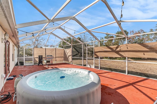 view of swimming pool with a hot tub and glass enclosure