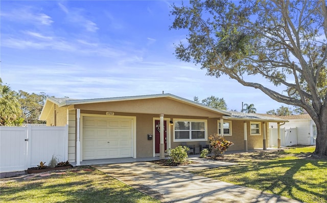 single story home featuring a garage and a front lawn