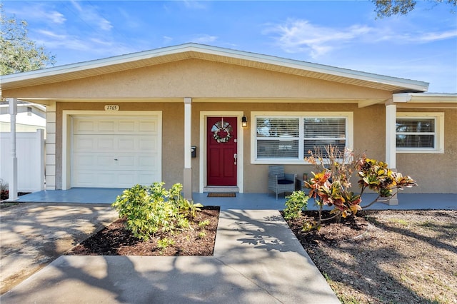 single story home with a garage and covered porch