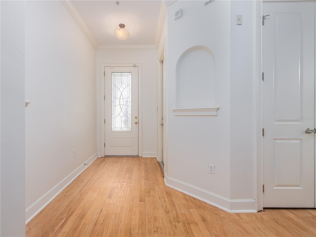 entryway featuring ornamental molding and light hardwood / wood-style floors